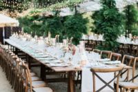 a simple and neutral outdoor wedding reception with white table runners and elegant candles