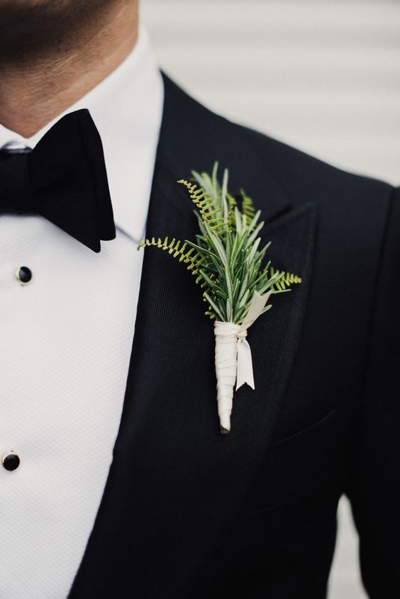 a simple modern greenery wedding boutonniere with a white wrap is a chic idea for a modern groom's look