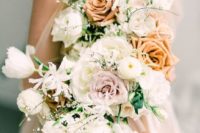 a soft pastel wedding bouquet with peachy and rust blooms, white flowers and blooming grasses