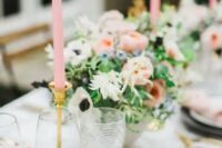 a spring garden wedding tablescape with pink candles and napkins, with pink and white blooms and greenery
