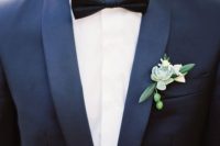 a stylish look with a navy tux, a black bow tie and a succulent and berry boutonniere is a gorgeous idea for a modern and exquisite outfit