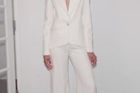 a stylish minimalist pantsuit with palazzo pants and a cutout blazer with long sleeves for a chic look