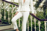 a stylish modern white pantsuit with no tops on and silver shoes for a modern or minimalist look