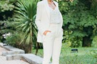 a stylish white pantsuit, a white fully embellished top and silver embellished shoes for an edgy look