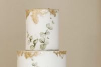 a subtle and sophisticated wedding cake with hand painted eucalyptus and gold leaf is amazing for a spring or summer wedding