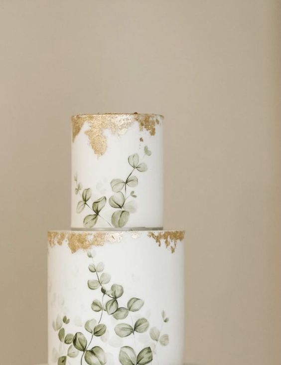 a subtle and sophisticated wedding cake with hand painted eucalyptus and gold leaf is amazing for a spring or summer wedding
