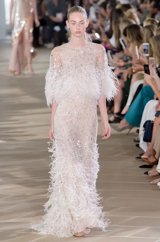 a super glam nude wedding dress with embellishments all over and feathers is a beautiful idea for a modern bride