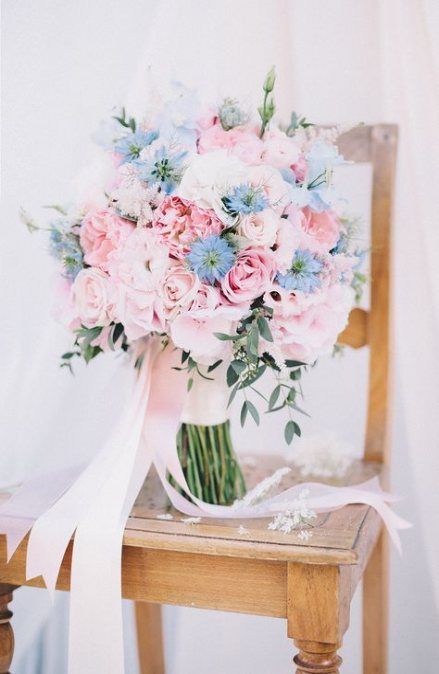 a sweet light pink and blue wedding bouquet plus greenery and blush ribbons for a spring bride