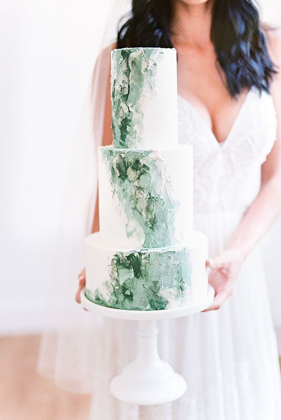 a white and green brushstroke wedding cake with much texture is a beautiful idea for a spring or summer wedding