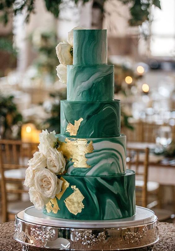 a white and green marble wedding cake with gold leaf and white roses is a bold and pretty idea to rock