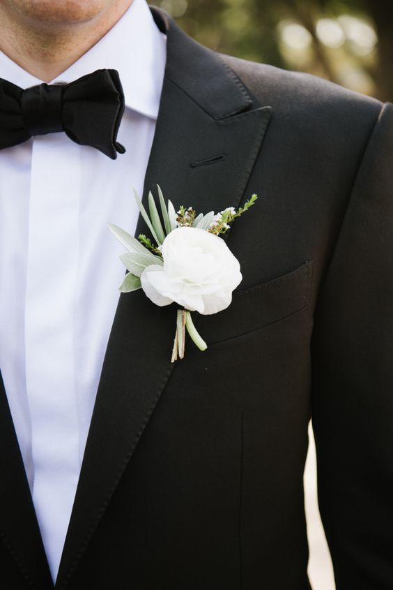 a white peony boutonniere with some greenery for texture is a chic idea to spruce up a classic black tux