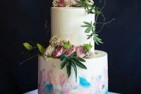 a white wedding cake with iridescent details and gold glitter, with fresh white and pink blooms and greenery