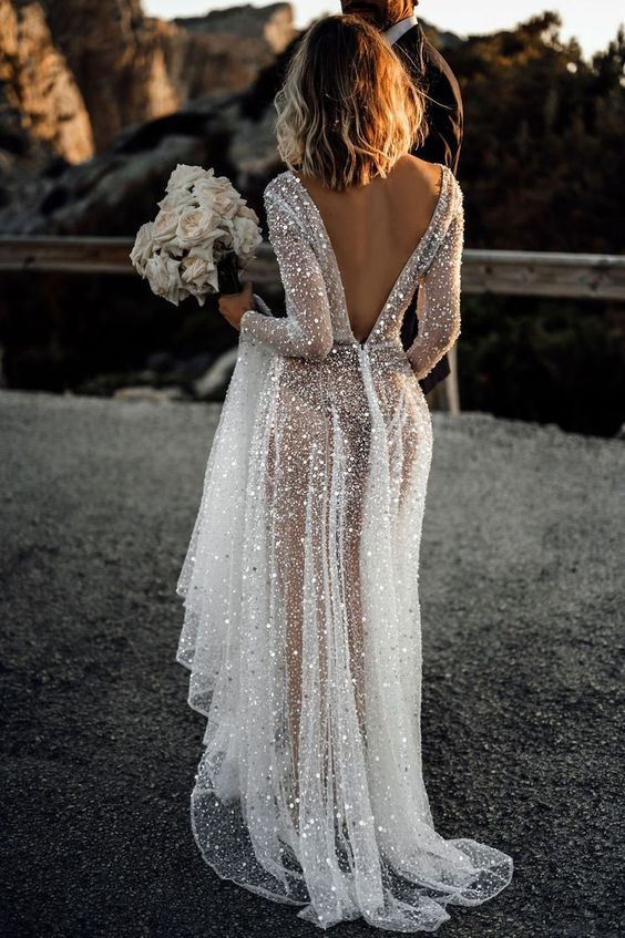 an A-line fully beaded wedding dress with a V-cut back and long sleeves plus a train is a gorgeous and super glam idea