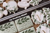 an assortment of beautiful green and white cookies is ideal for such a monochromatic wedding