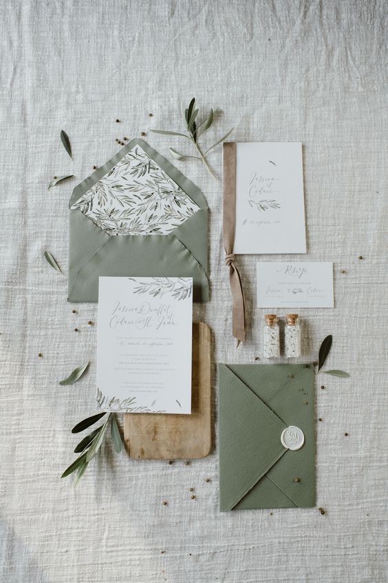 an olive wedding inivtation suite in olive green and white, with calligraphy and botanical prints is amazing