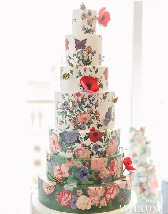 an oversized wedding cake with white and green tiers, with handpainted flowers and sugar blooms is a gorgeous statement