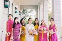 bridesmaids wearing mismatching hot pink, fuchsia, yellow dresses compose a very colorful bridal party