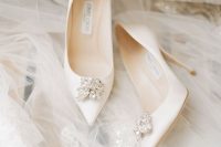 classic and elegant white wedding shoes with large embellishments are a fantastic idea for a classic bridal look