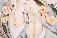 gorgeous white wedding shoes with silk ribbon straps and large pearls for a touch of glam and chic