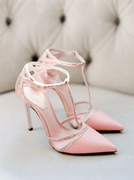 pink wedding heels with T ankle straps and embellishments are perfect for a glam bride, and they will add a peachy touch to the look