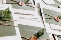 woodland wedding invitation suite with white and olive green cards, twine, seals and fern is ultimate