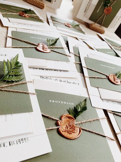woodland wedding invitation suite with white and olive green cards, twine, seals and fern is ultimate
