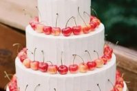 100 a white buttercream wedding cake lined up with cherries is a lovely idea for a summer wedding, it’s cool and chic