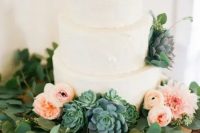 114 a white textural buttercream wedding cake with a greenery wreath, blush and light pink blooms and large succulents is a brilliant solution for a modern wedding with much greenery