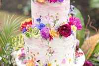 118 a white textural wedding cake with pink brushstrokes and super bold fresh blooms in all the shades of rainbow