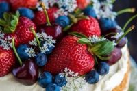 12 a one-tier naked wedding cake topped with whipped cream with fresh berries, greenery and blooms is a beautiful and cool idea for a summer wedding