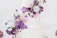 120 a white wedding cake that received a touch of color with white, pink and purple blooms looks lovely and such decor can be easily added or removed