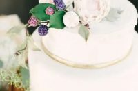 121 a white wedding cake with a gold ribbons, neutral blooms and sugar foliage plus berries on top for a summer wedding