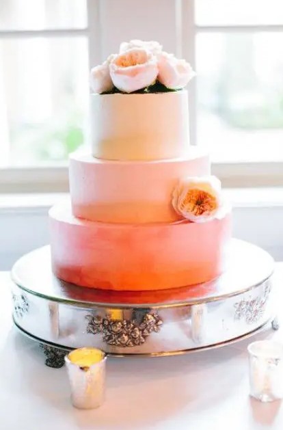 an ombre peachy wedding cake decorated with a single matching bloom is a lovely idea for a summer wedding
