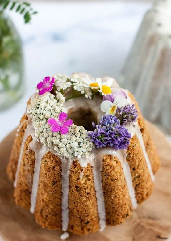 a beautiful bundt wedding cake with creamy drip, fresh blooms on top is a great idea for spring and summer