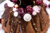 131 a chocolate bundt wedding cake with chocolate drip, gold leaf, fresh cherries, meringues and beads is a lovely and glam idea