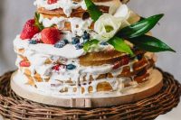 133 a delicious waffle wedding cake with cream drip, fresh berries, foliage and white blooms is very summer-like