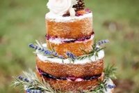 14 a naked wedding cake with lavender, blooms, pinecones and macarons is a trendy and yummy rustic wedding cake