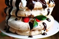 142 a pavlova cake with chocolate, raspberries, leaves and some drip is a delicious idea that everybody will enjoy