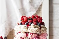 143 a pavlova wedding cake of three tiers – a hot pink, light pink and white one, with lots of delicious berries and berry drip for a summer wedding