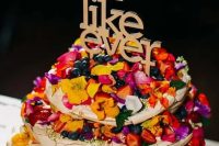 145 a pavlova wedding cake with colorful petals, bright berries and a letter topper is a lovely idea for a bright boho wedding