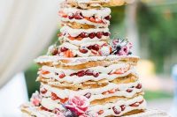 146 a waffle wedding cake with creamy filling, lots of berries and fresh blooms for a rustic brunch wedding in summer