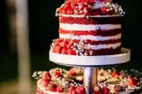 23 a red velvet wedding cake with white baby’s breath and fresh berries is a gorgeous idea for a rustic wedding