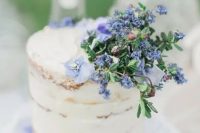 27 a spring or summer naked wedding cake topped with blue blooms is a cool idea for a pastel wedding