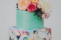 34 a beautiful colorful wedding cake with a mint green and bold textural brushstroke tier, bold blooms and thistles on top