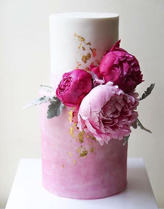 a beautiful white and watercolor pink wedding cake with gold leaf and bold pink and light pink peonies is a gorgeous idea for summer