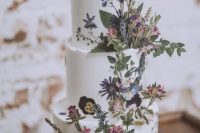 40 a boho summer three-tier wedding cake with dried blooms and leaves, pressed and dimensional, looks beautiful
