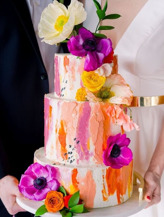 a bold wedding cake with colorful dimensional brushstrokes plus bold flowers and greenery is a vivacious idea to rock