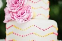 48 a bright summer wedding cake with pink and yellow chevron polka dot patterns and pink sugar blooms is a gorgeous idea to rock