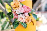 50 a bright yellow wedding cake with blush, peachy, pink and white blooms and leaves is a cool and fun idea to rock
