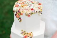 53 a chic hexagon white wedding cake with colorful sugar and pressed blooms and foliage is a gorgeous idea for a secret garden wedding